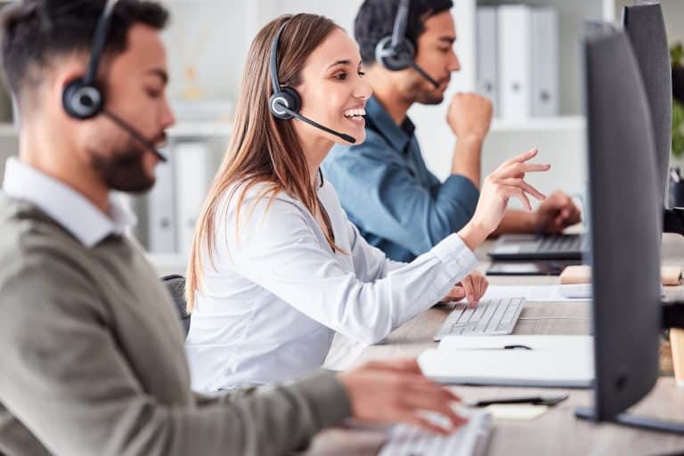 Customer support agents wearing headsets handling enquiries, showing multi-channel support and faster response workflows.