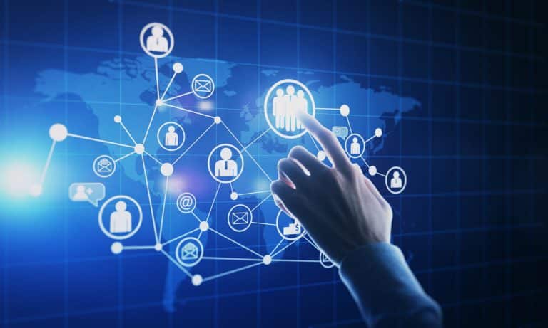 Hand selecting a digital network icon on a world map interface, representing connected support channels, workflow decisions, and choosing the right service platform.
